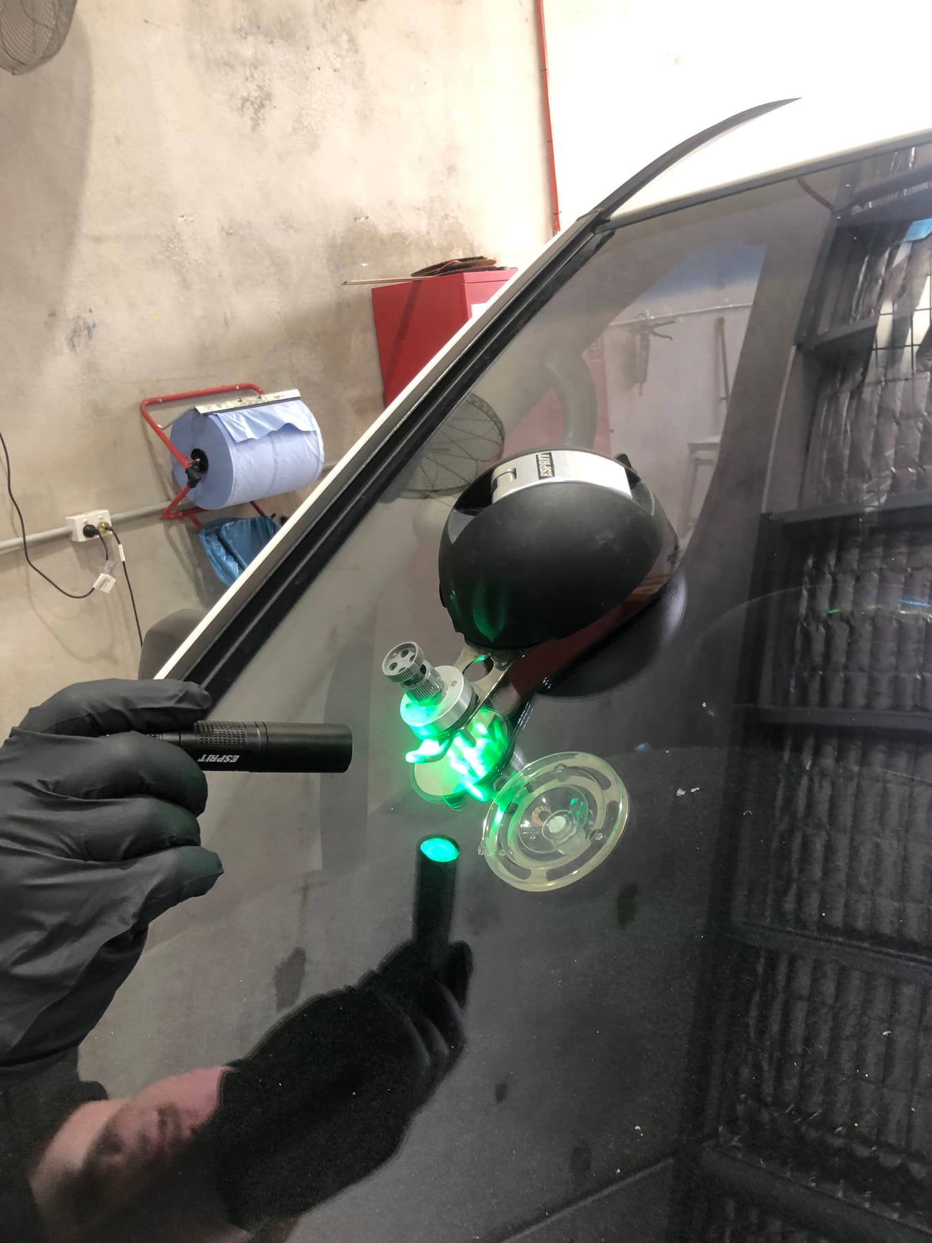 Windscreen chip repair Morayfield — resin cured in a stone chip under a green UV lamp